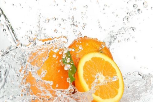 Water sprayed on oranges